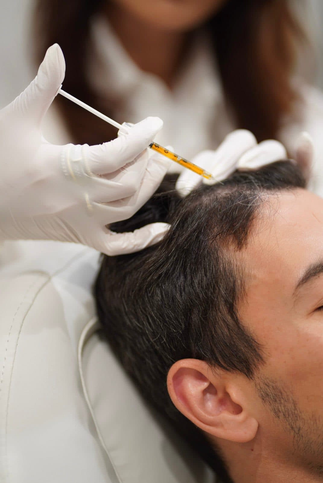 Provider performing a precise injectable treatment on a seated client